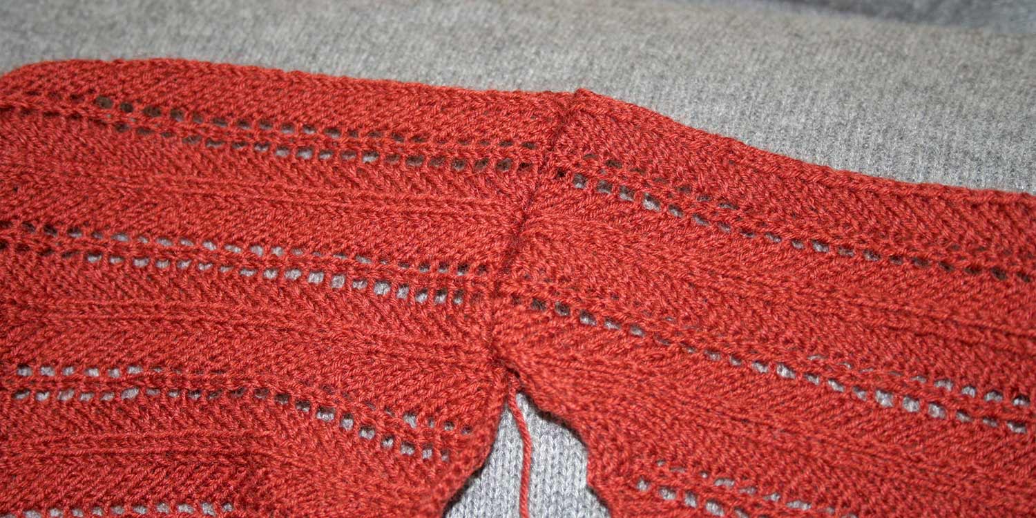 Straight shoulder seam of a back and front opened up and viewed from the right side.