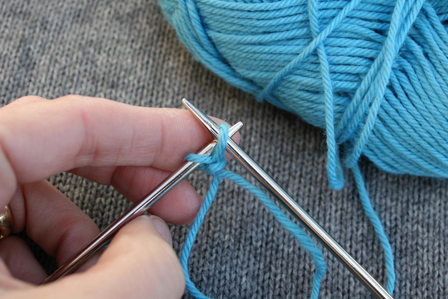 Both right and left needles are crossed and going through the same stitch as it's being transferred from right to left needle.