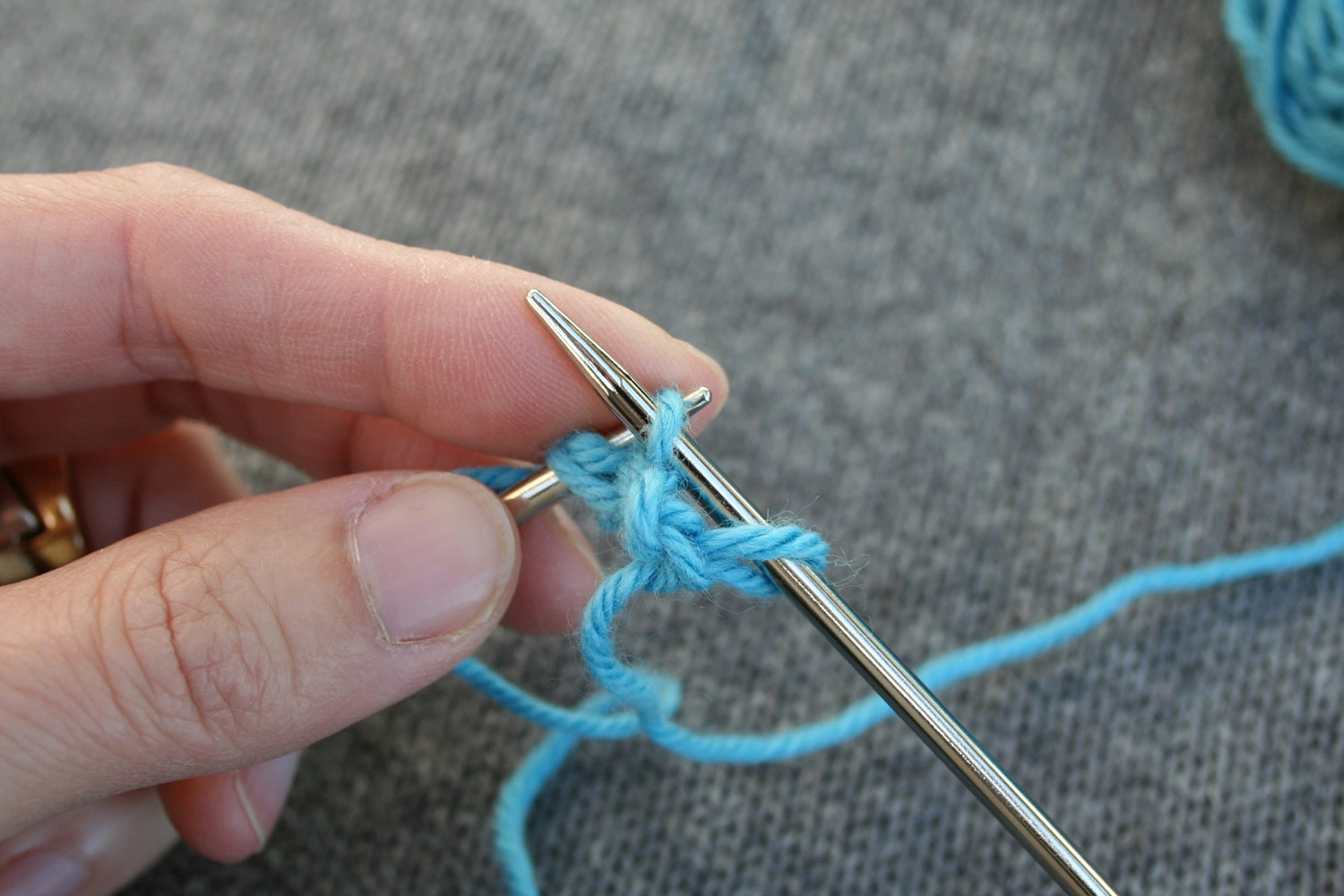 Right needle, with one stitch on it, is inserted purlwise into the next stitch on left needle.