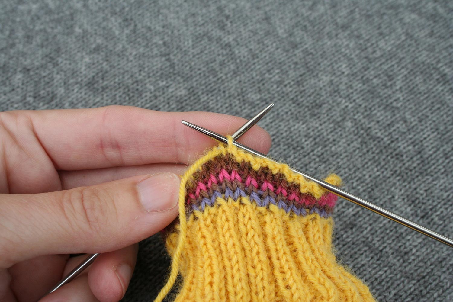 Bind off being worked; right needle inserted purlwise into first stitch on left needle with working yarn threaded through second stitch on left needle.