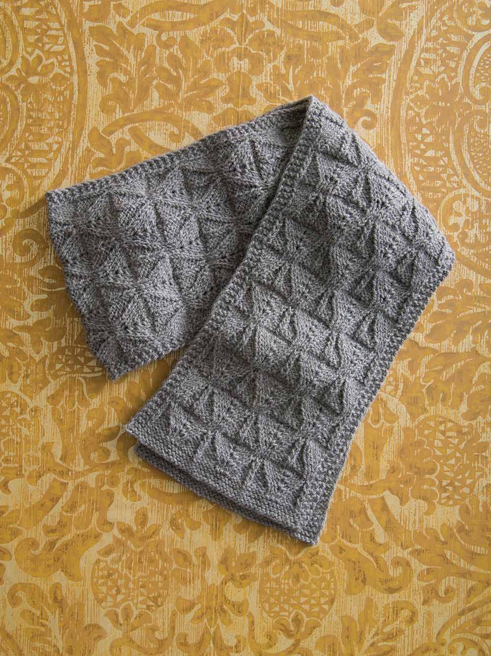 Grey scarf with an alternating triangle stitch pattern.