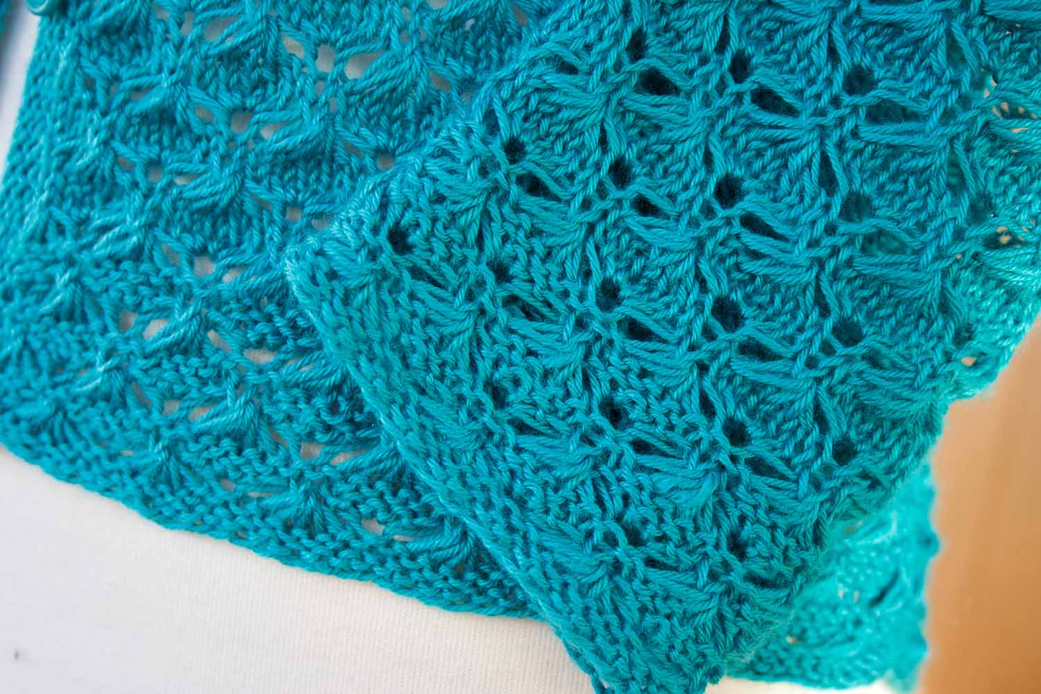 Detail shot of cuff and hem of lacy cardigan.