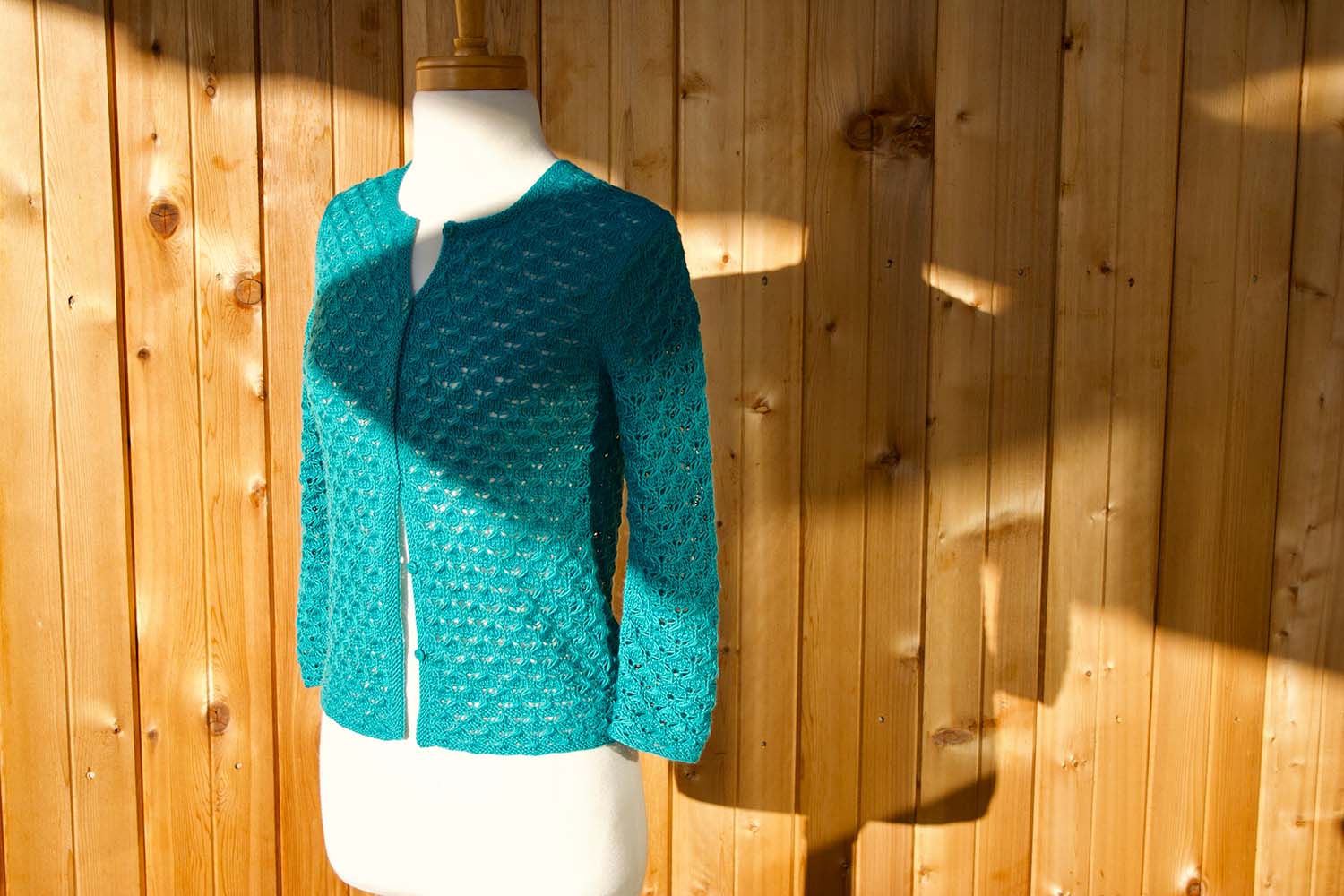 Three-quarter view of Classic Lace Cardigan on dress form.