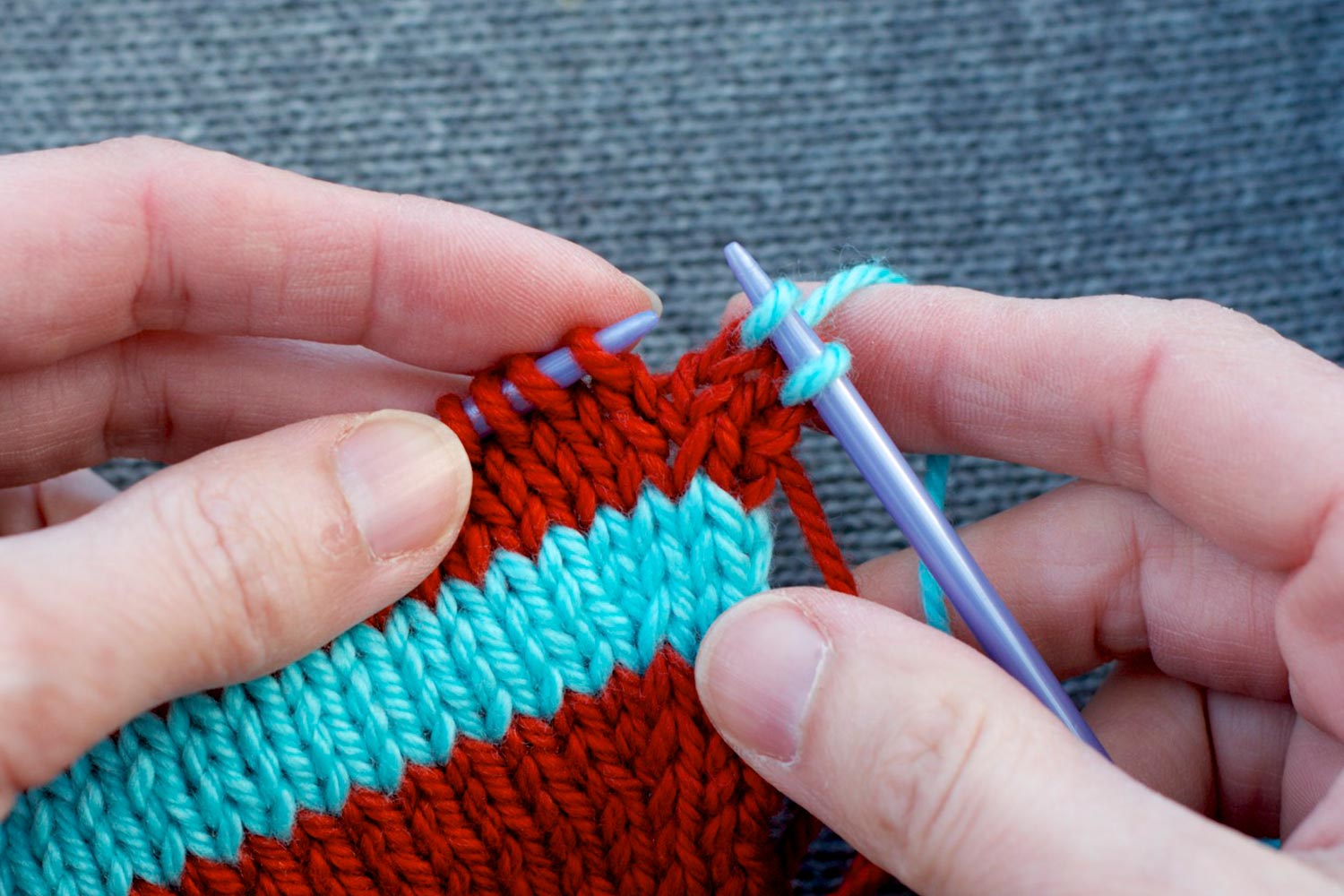 Two stitches worked on right needle with remaining stitches still to be worked on left needle.