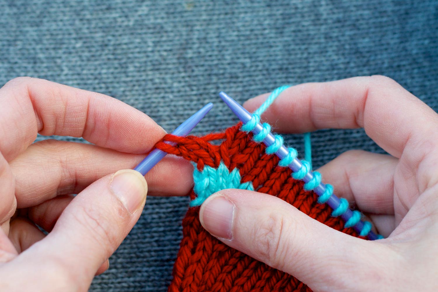 Stitches on the needles with only two stitches remaining on left needle. Also showing bar between the stitches on both needles.