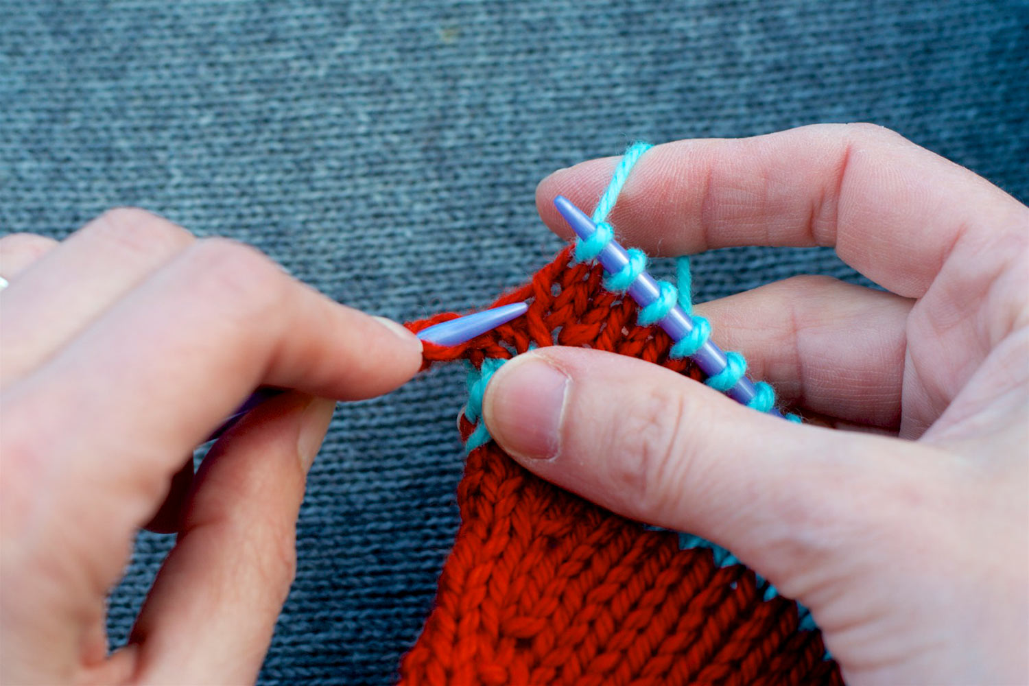 Tip of left needle just below and parallel to bar between stitches.