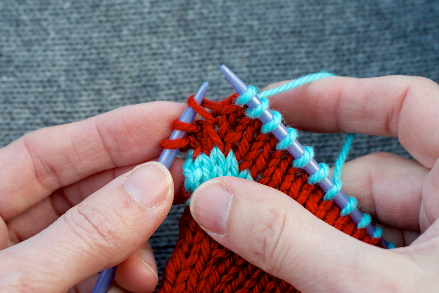 Left leg of stitch two rows below last stitch on right needle is raised onto left needle.