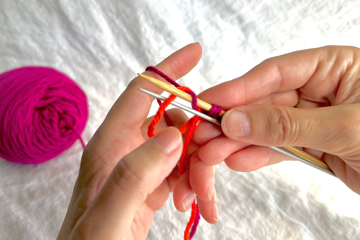 Thumb loop is dropped off thumb while maintaining yarn setup in rest of hand.