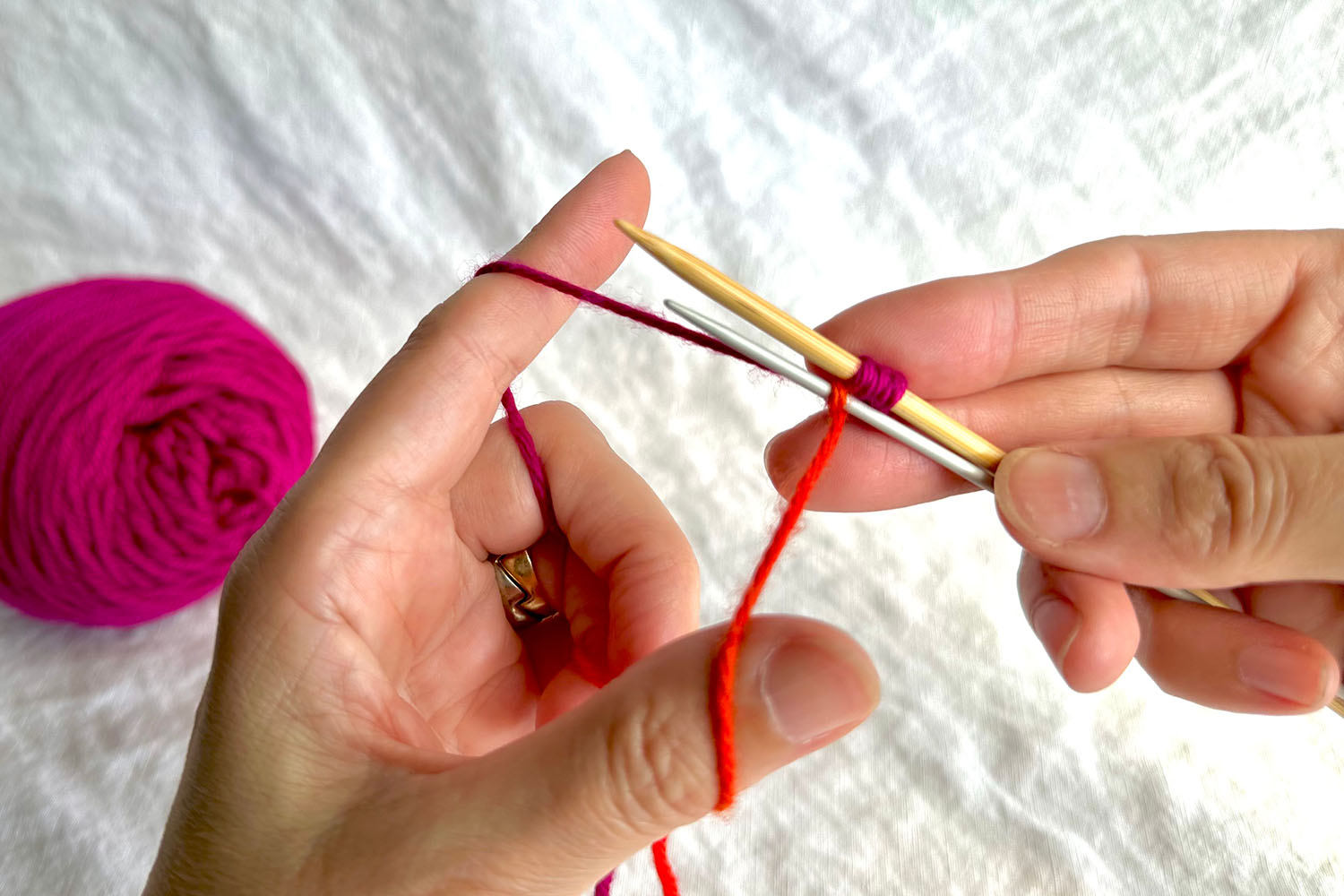 First Double Needle Cast On stitch is complete; 3 stitches on gauge needle and 1 stitch on smaller needle.