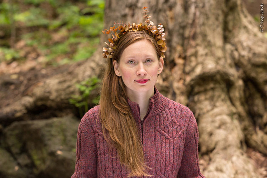 Zippered cardigan with cable panels, stand up collar, set-in sleeves, and English-tailored shoulders.