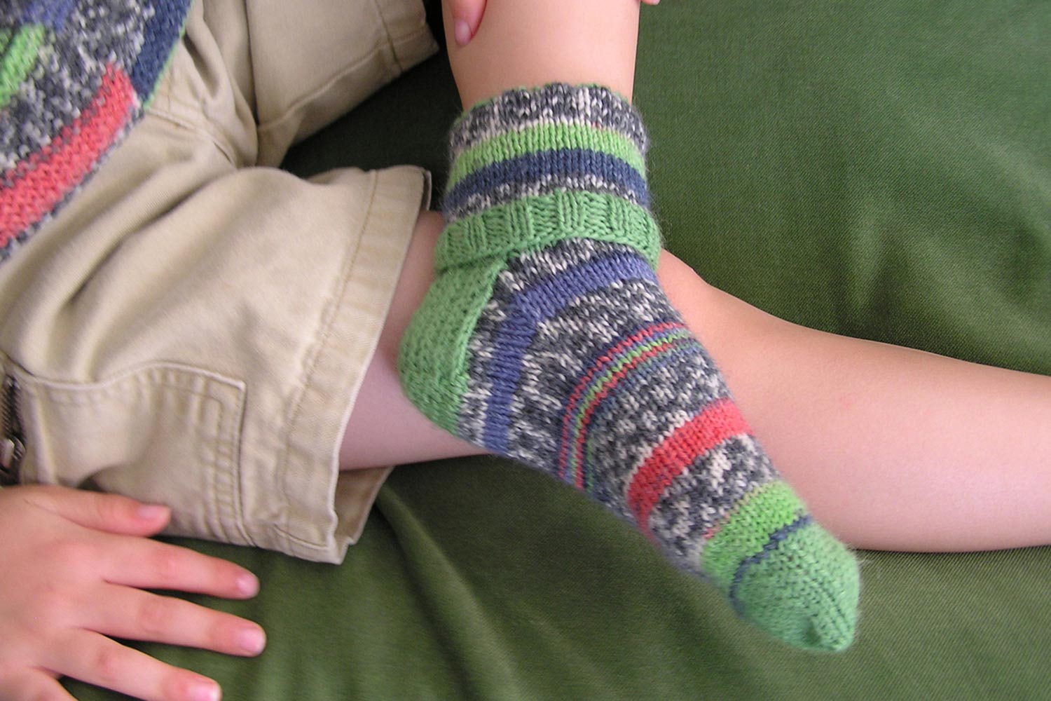 Kids socks pattern featuring a folded over cuff are worked top down with a heel flap and heel turn construction.