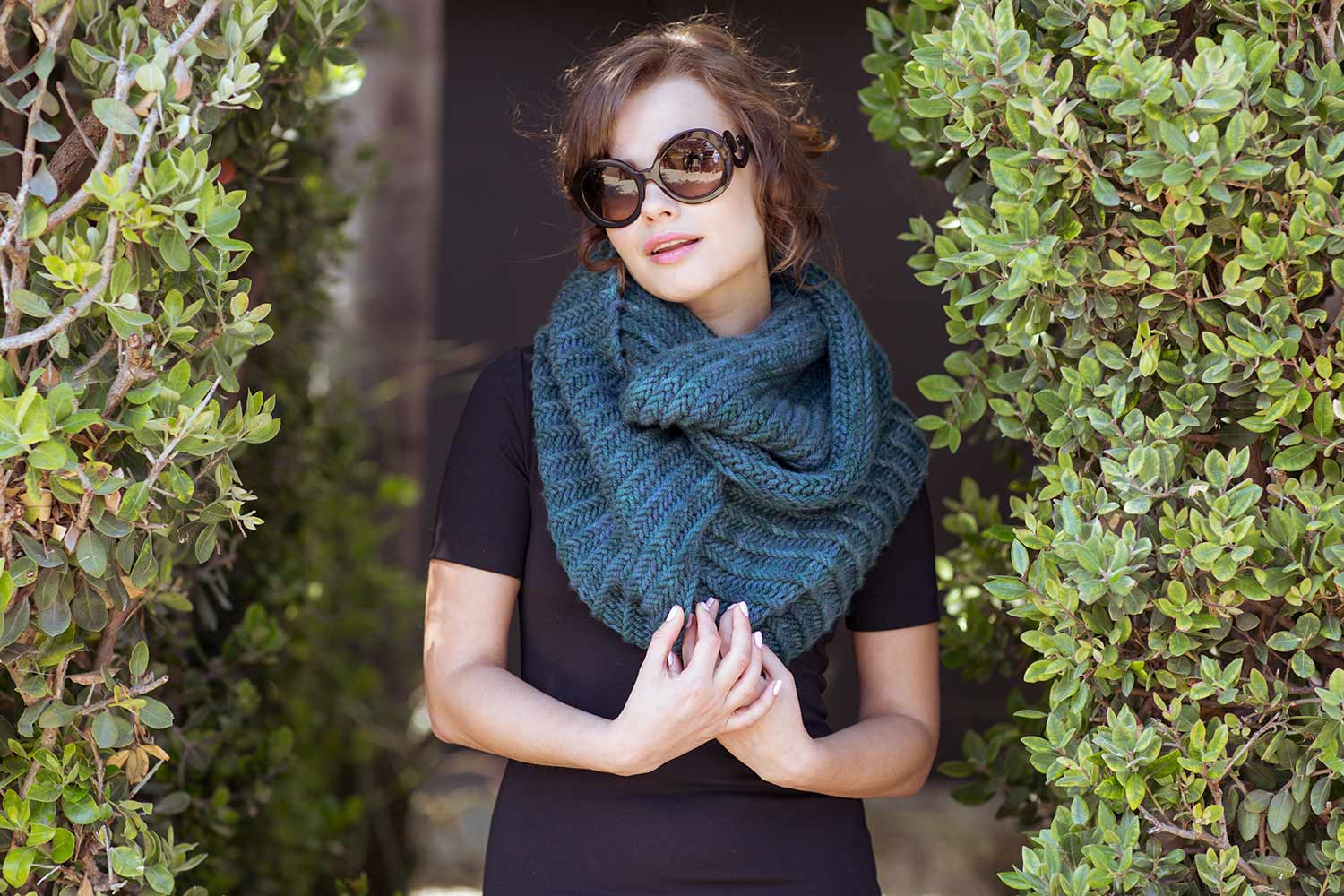 Huge bulky cowl with textured ridges wrapped twice around the neck.
