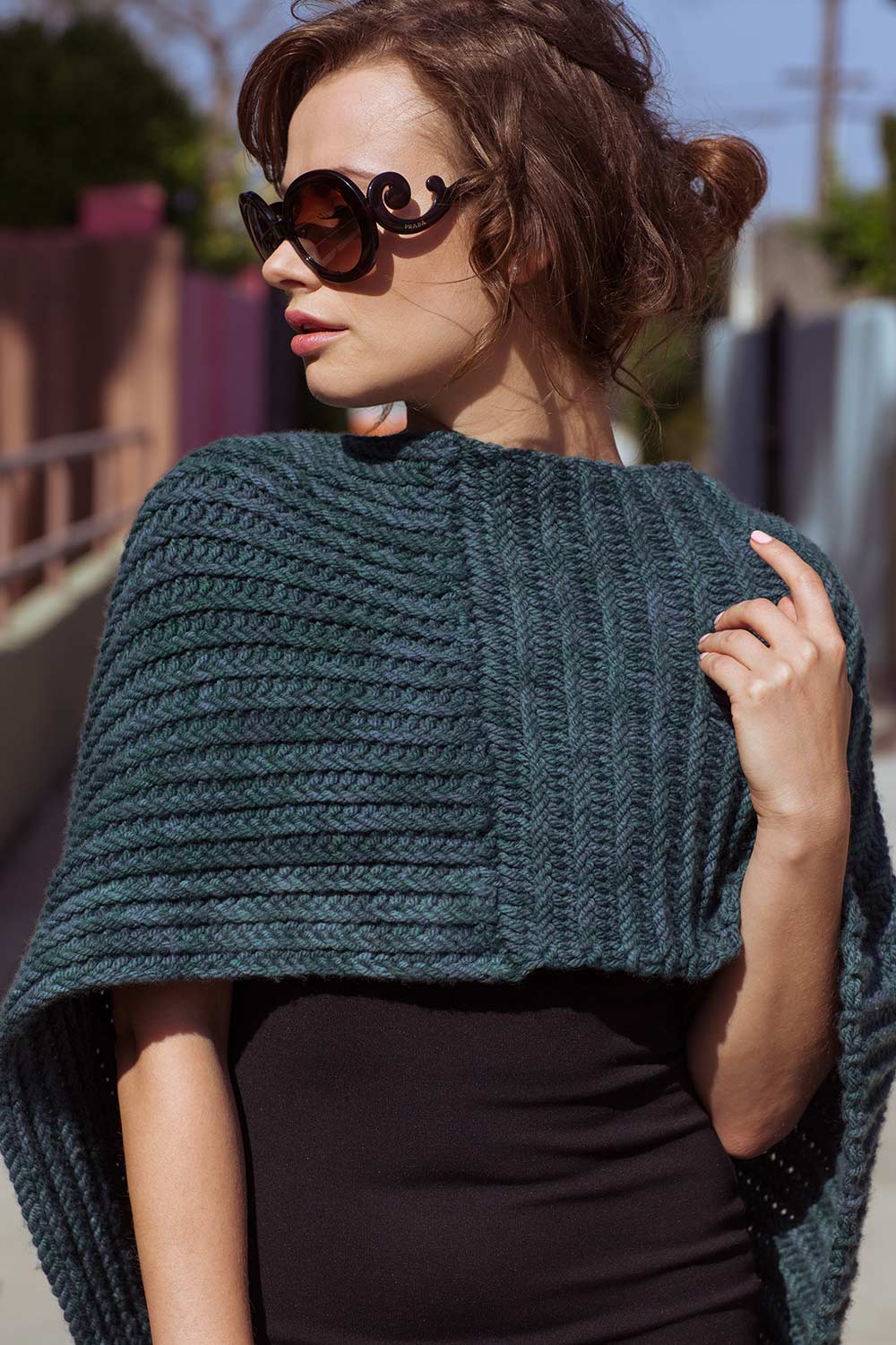 Large, bulky cowl draped over front shoulders and hanging down back. Detail of textures stitches is very clear.