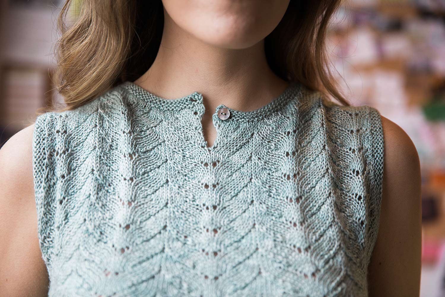 Detail shot of lace pattern worn on front of reversible shell.