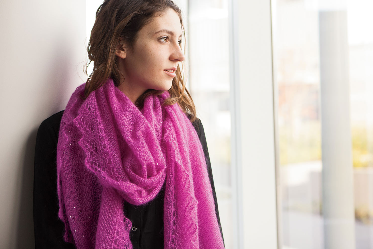 Voluminous mohair shawl wrapped once around the neck with both ends hanging at the front. Lace edging and little pin pricks of beads catching the light can be seen.