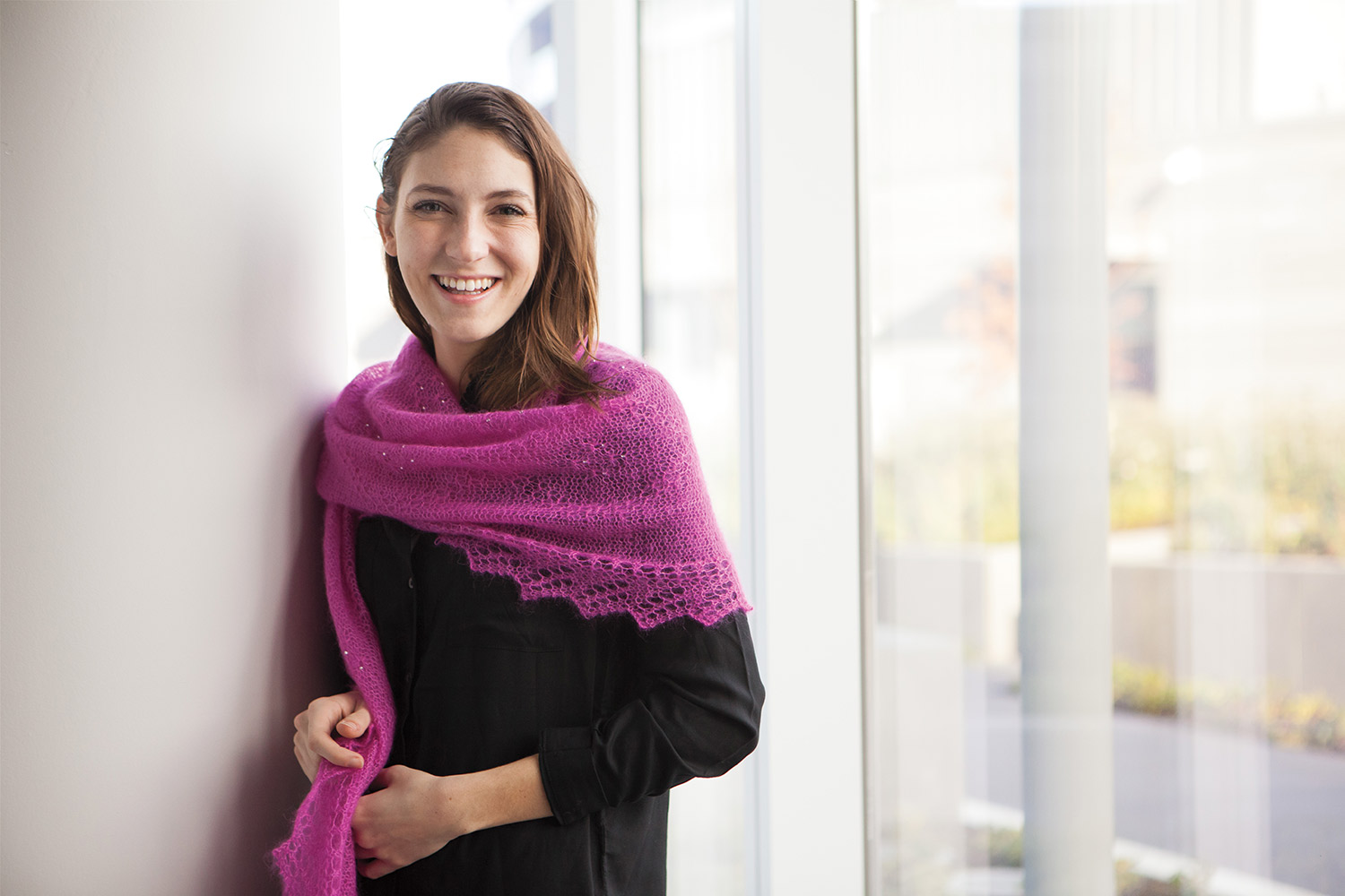 Stole wrapped around the shoulders with both ends hanging down one side. Sawtooth style lace edging and subtle stitch pattern can be seen.