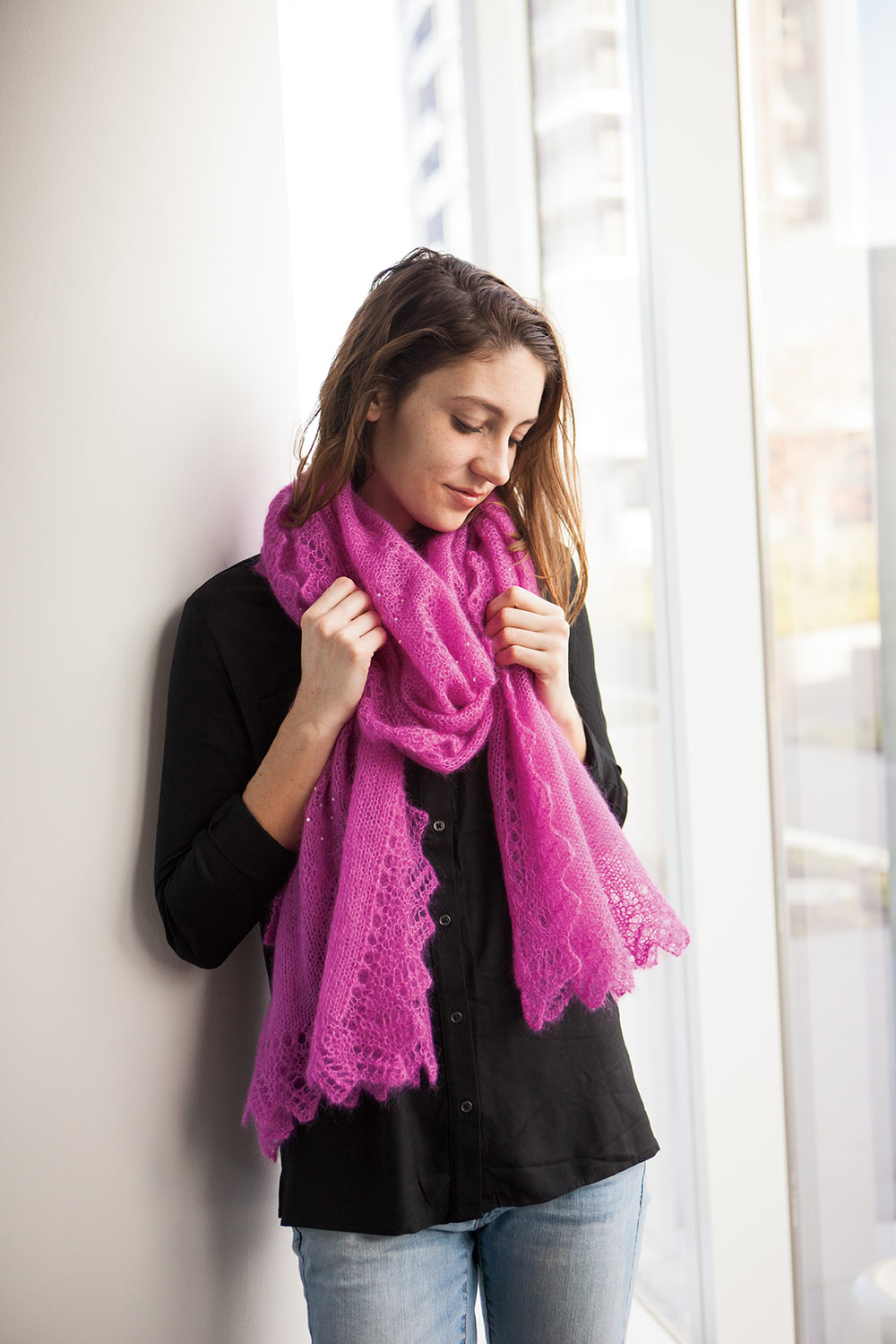 Mohair rectangular shawl wrapped once around neck and lace-edged ends hanging at waist length.