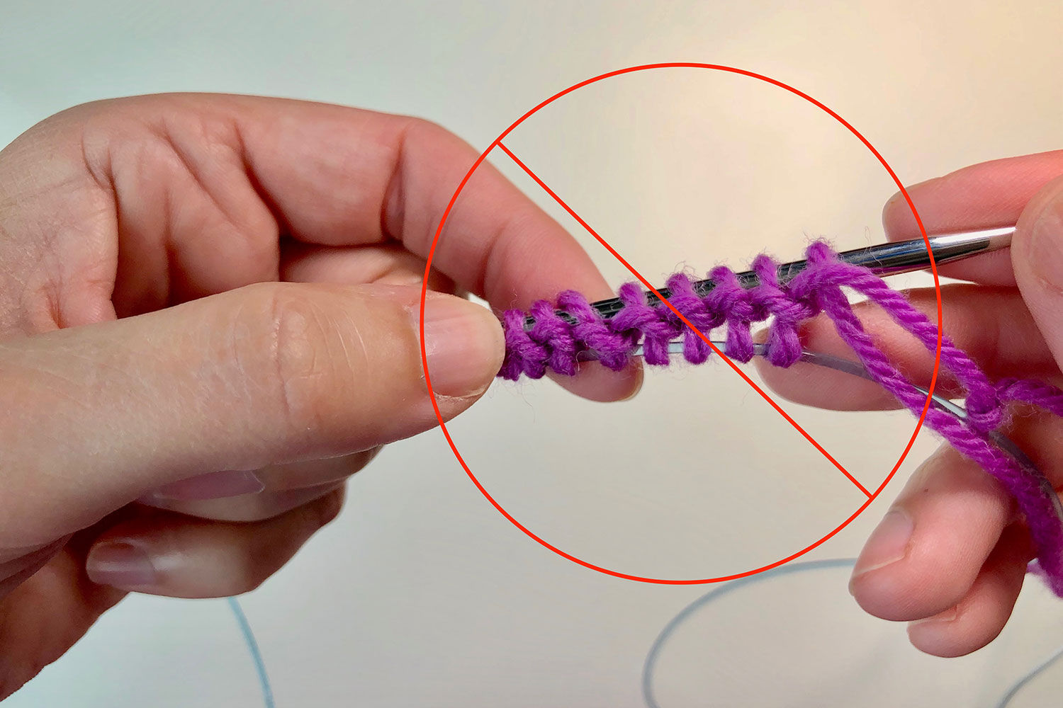 The purl bumps showing the wrong side of the Turkish cast on and a big red circle with a cross through it.