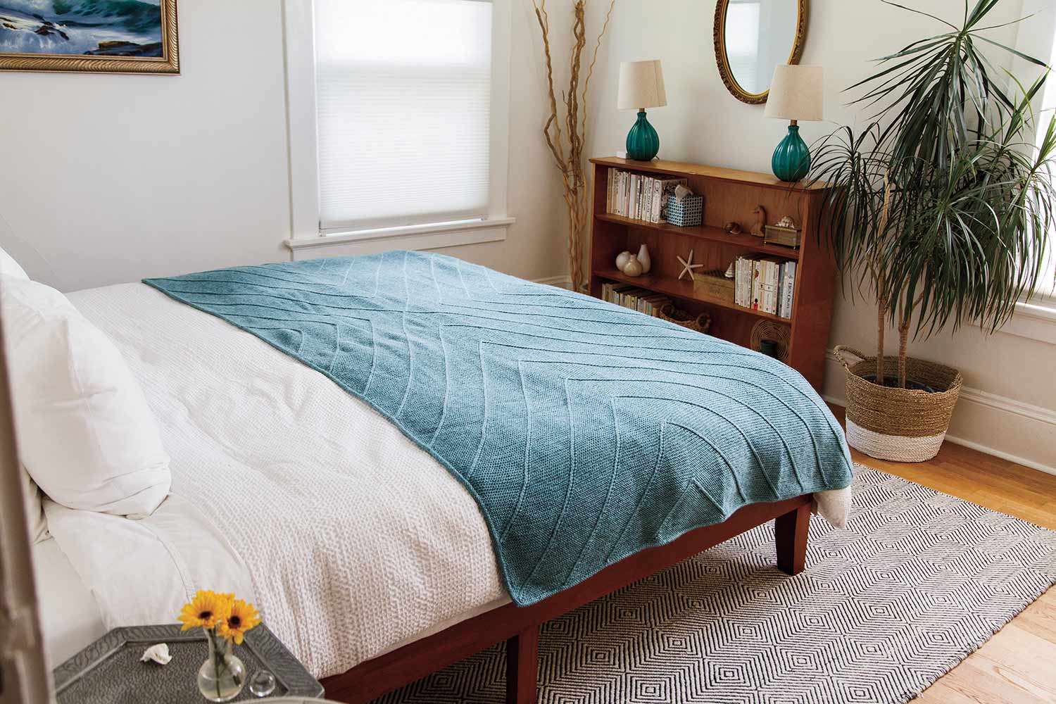 Blanket spread out on bed showing textured cross shape.