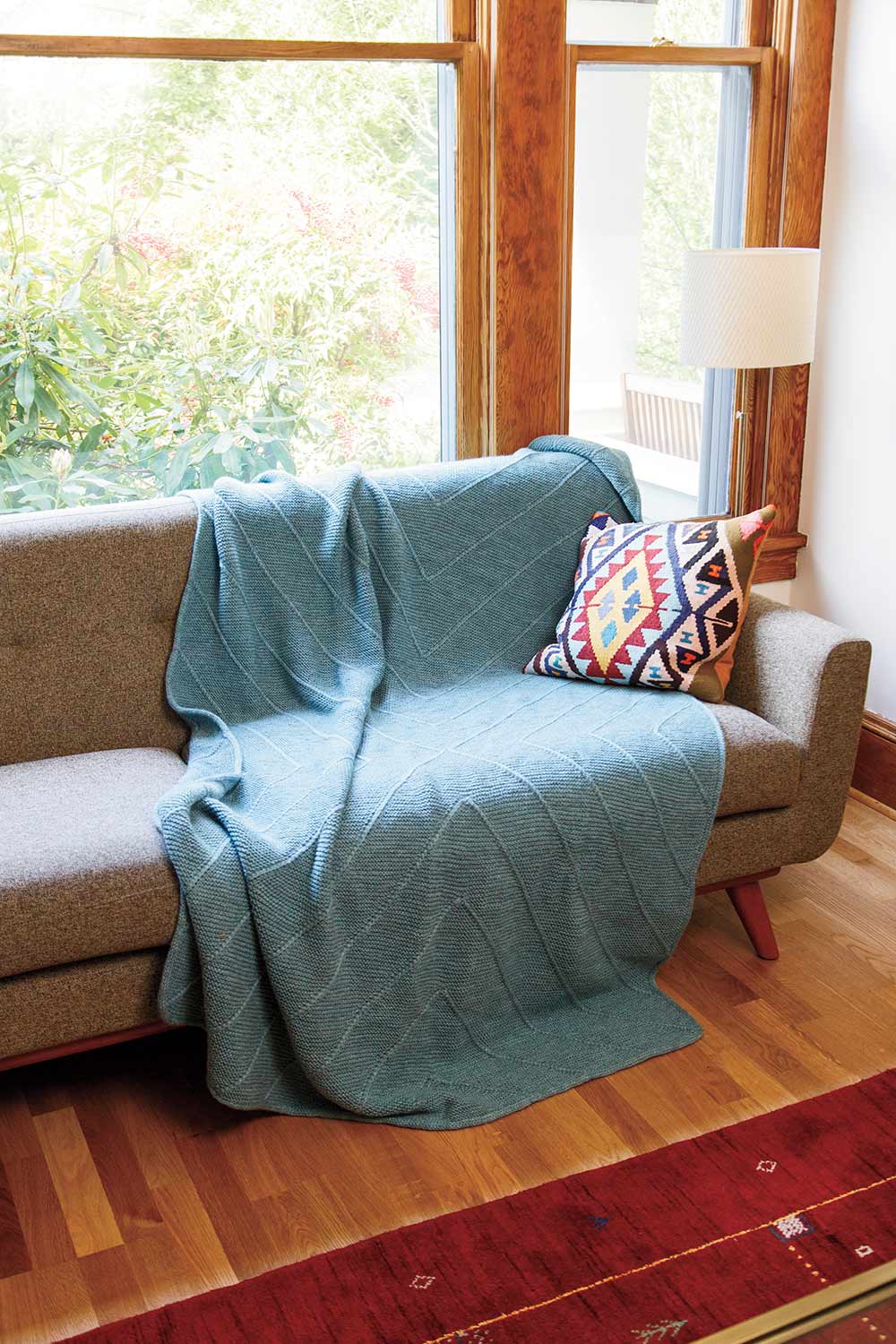Large blanket draped on a couch.