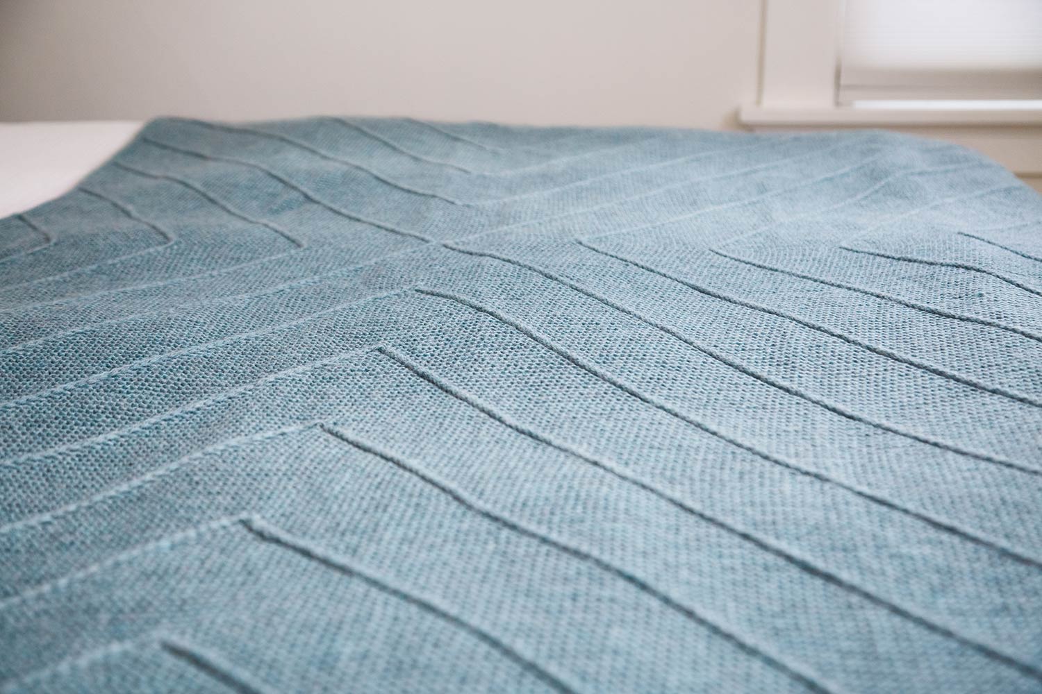 Detail shot of diagonal lines on a blanket.