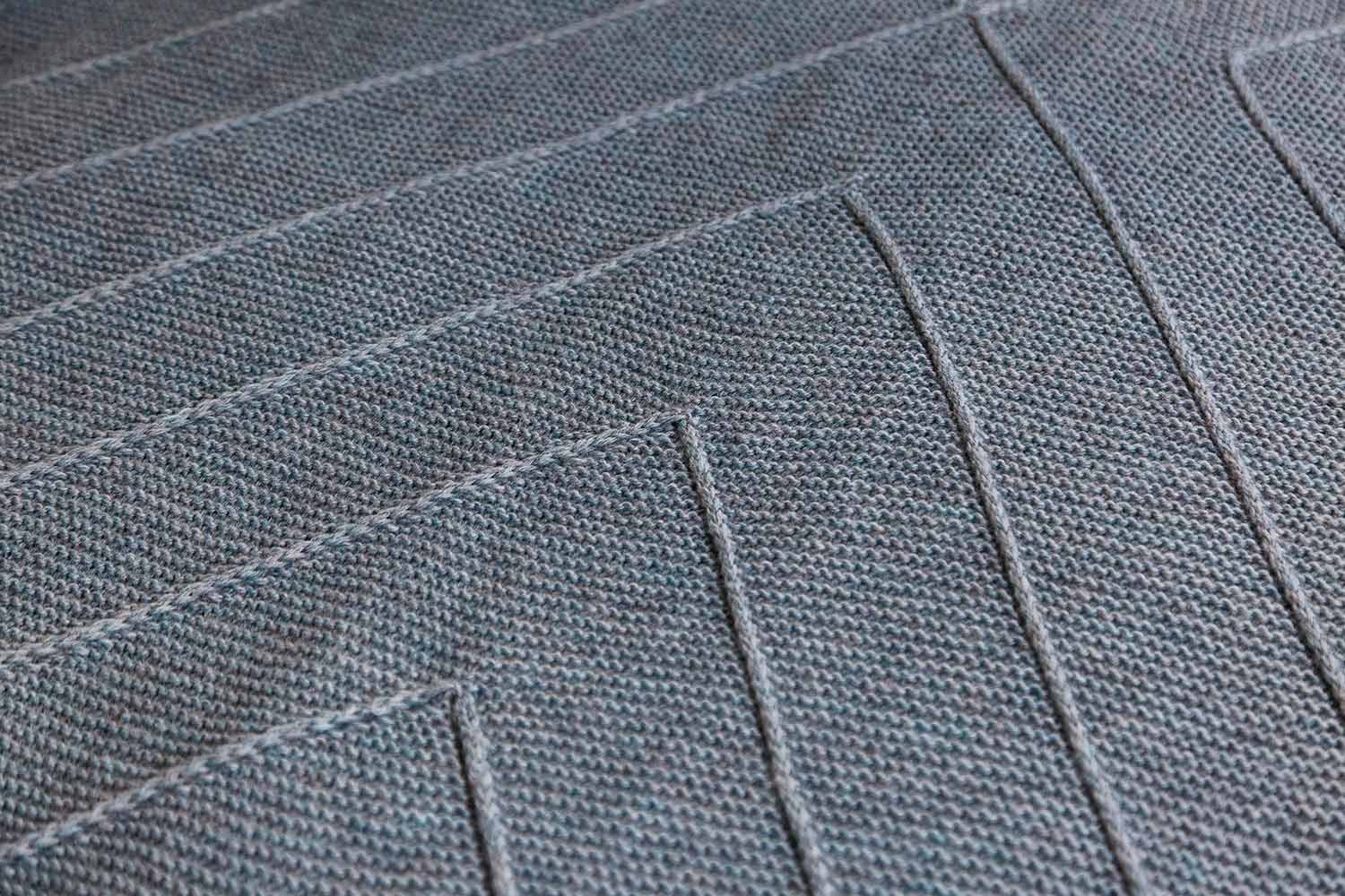 Detail shot of inverted chevron lines on a garter stitch background.