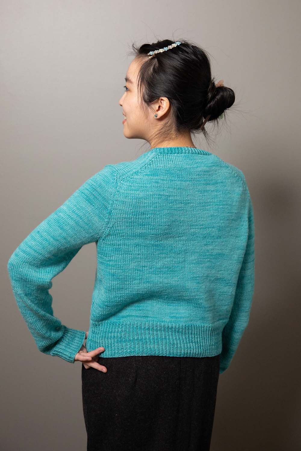Back view of modeled cardigan showing English-tailored shoulder shaping on back shoulders.