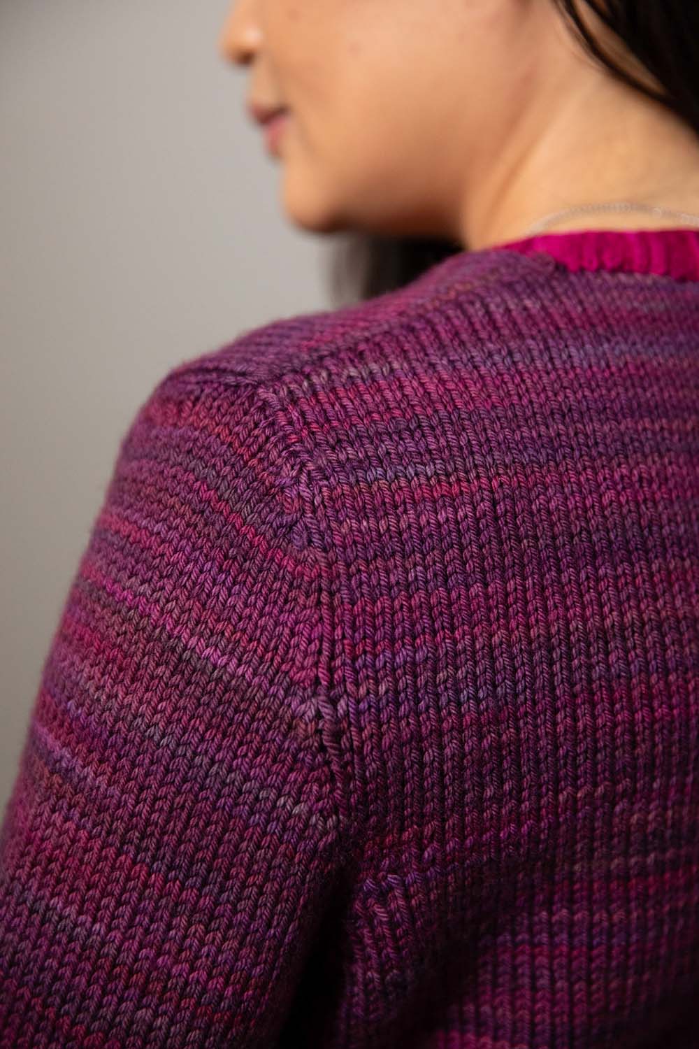Detail shot of shoulder showing inside sleeve on modeled cardigan.