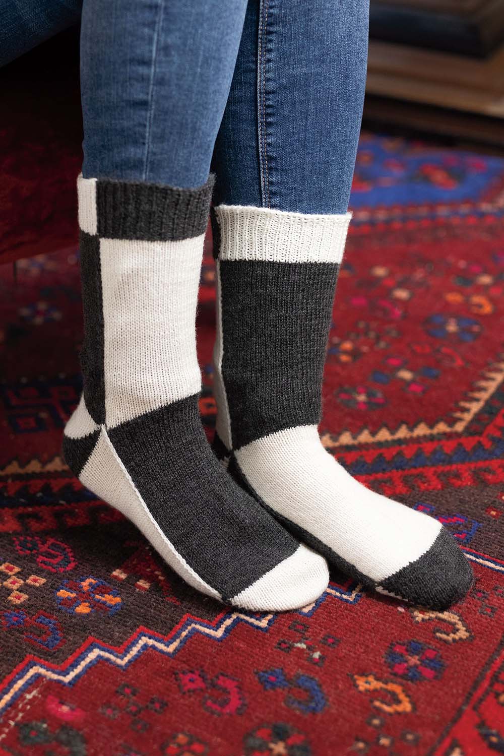 Black and white colourblock socks worked flat; colour changes on each section of the sock.