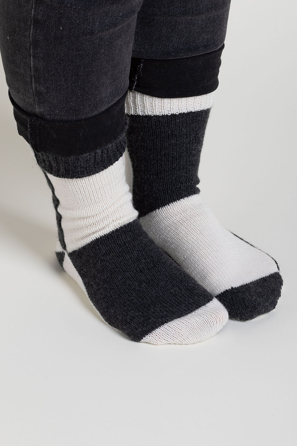 Black and white colourblock socks worked flat; colour changes on each section of the sock.