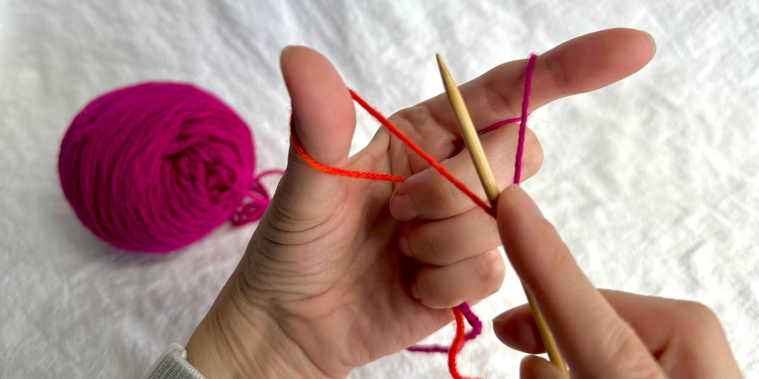 Starting position for long tail cast on with yarn set up in left hand.