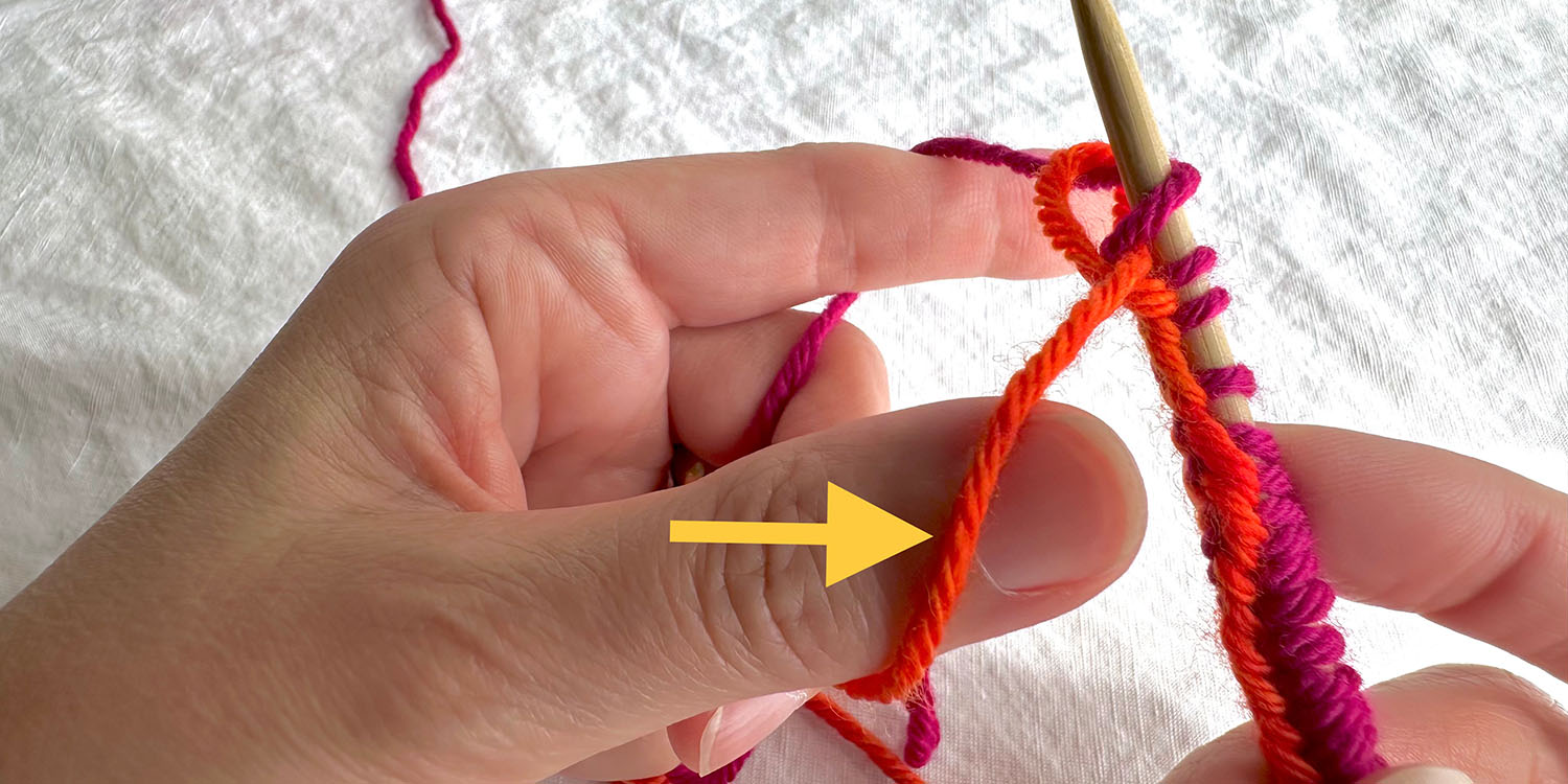 Thumb slipped behind dropped tail strand with directional arrow.