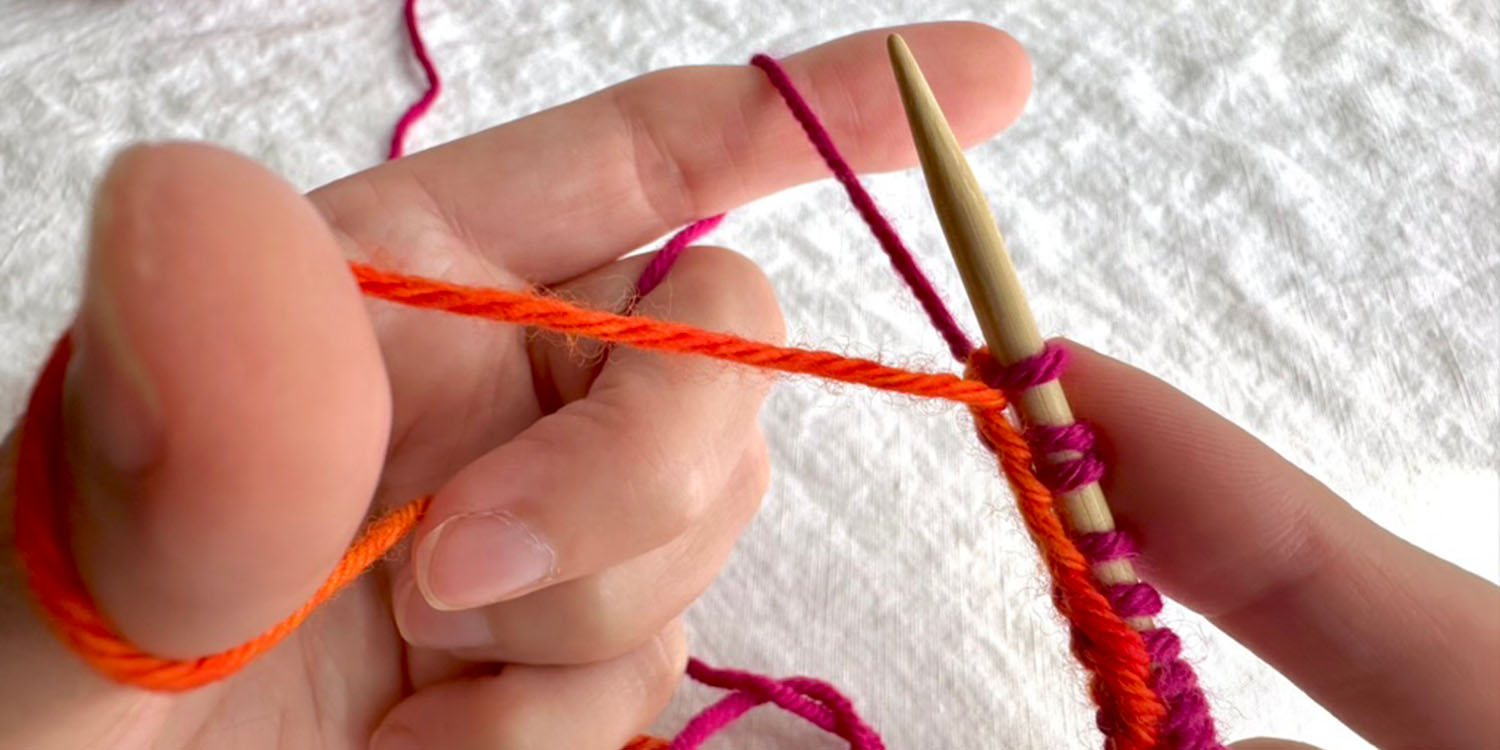 Left hand set up for starting position for long tail cast on with stitches on needle in right hand.