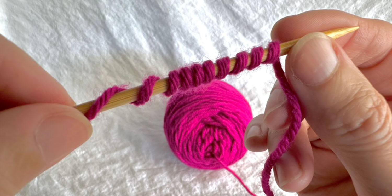 Yarn wound around a needle ten times.