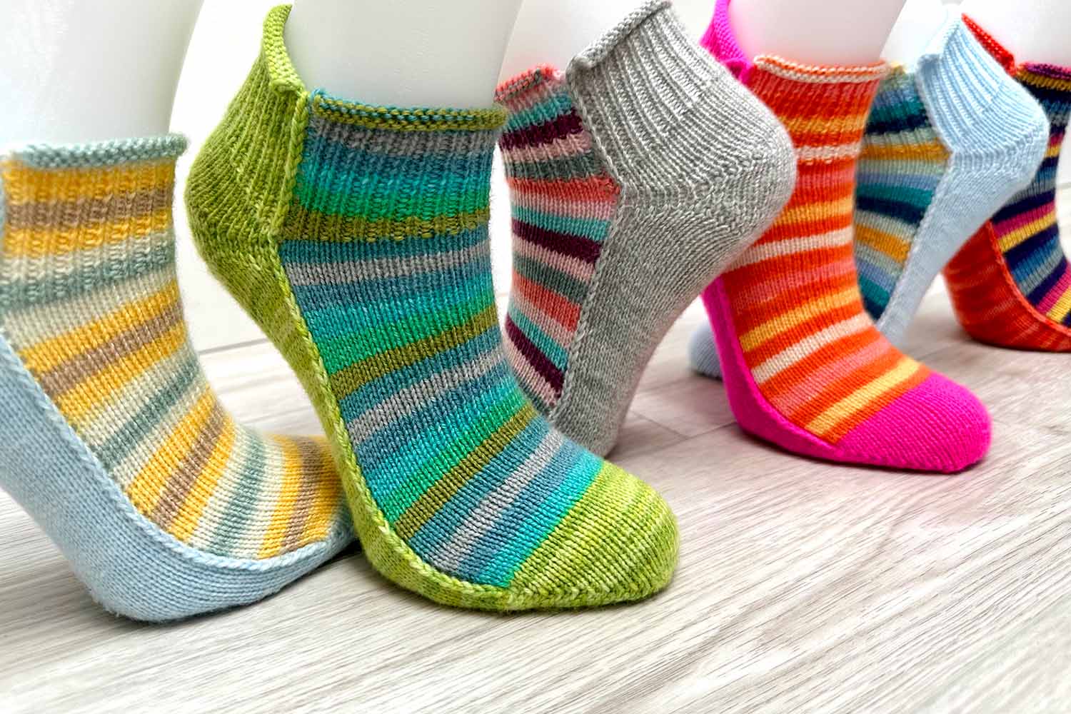 Six foot forms sporting colourful shortie socks with striped insteps and solid soles.