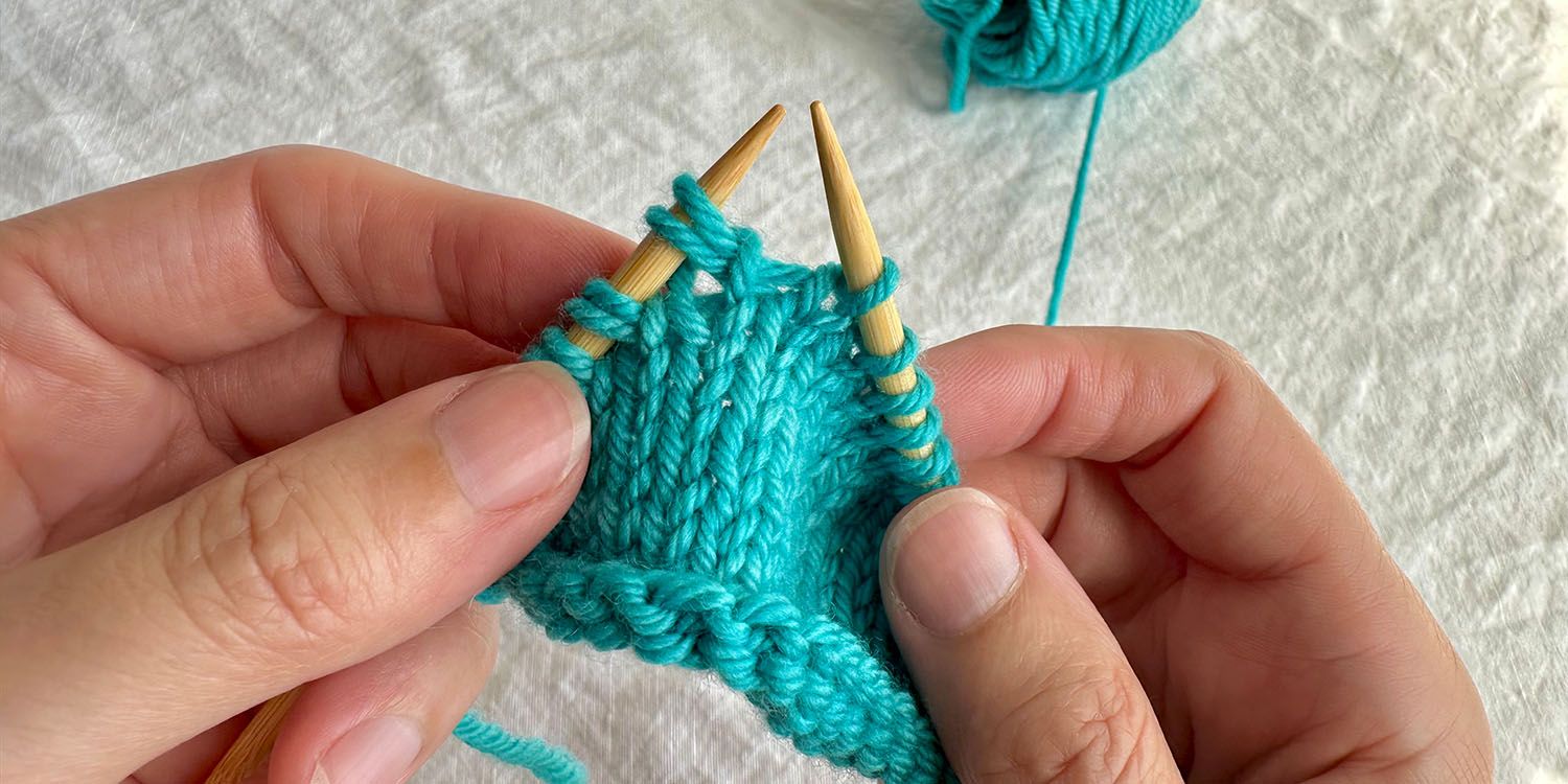 Raised increase has been transferred to left needle creating a twin stitch.