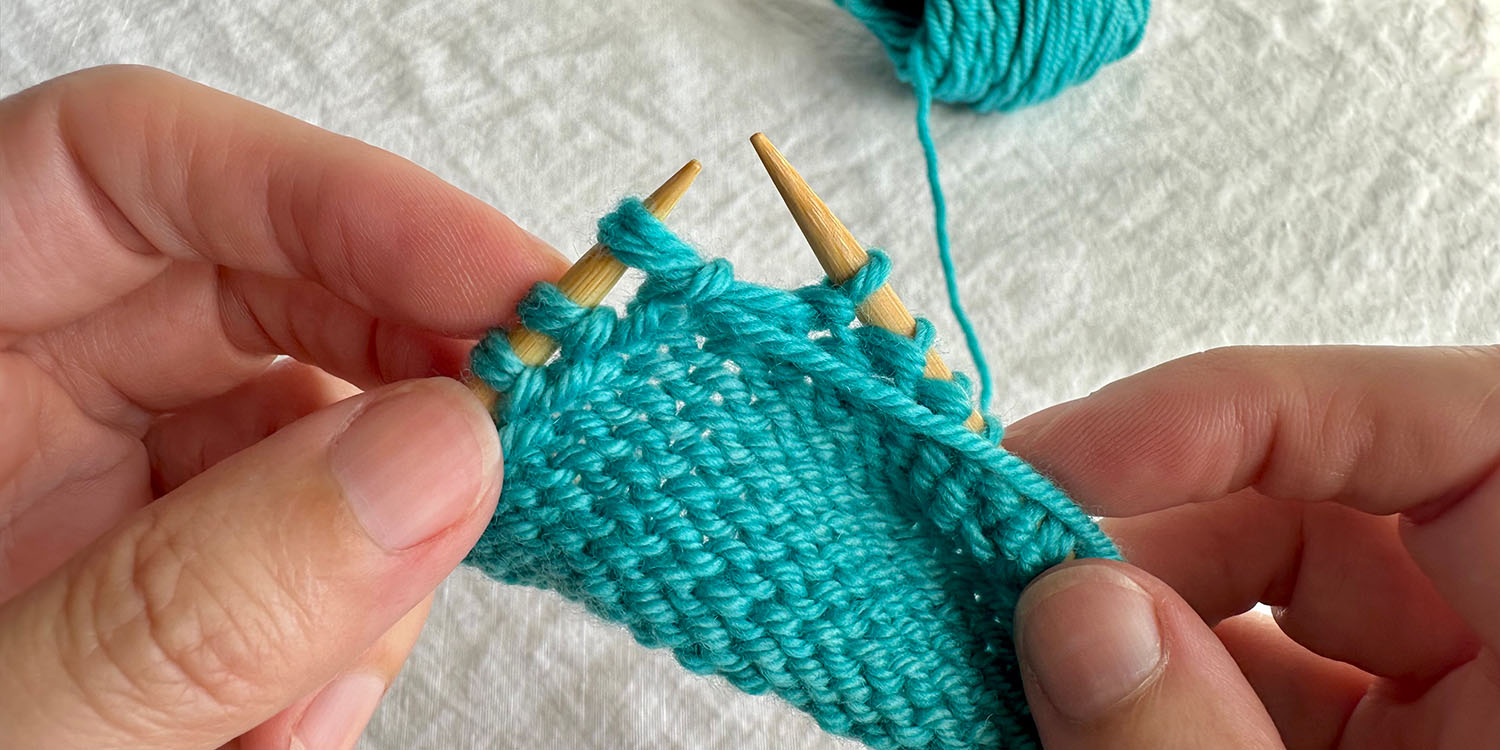 With wrong side facing, twin stitch is on left needle; twin stitch is completed.