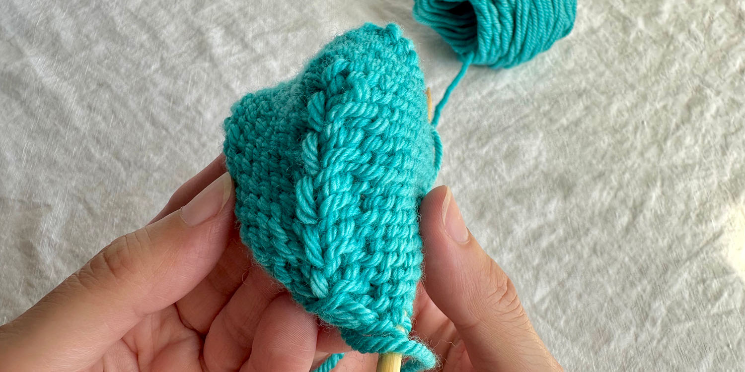 Toe sample in worsted weight yarn showing completed short row shaping from wrong side.