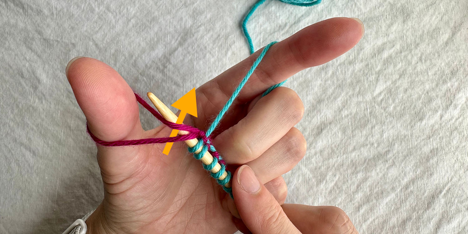 Needle inserted under both strands of thumb loop with directional arrow.