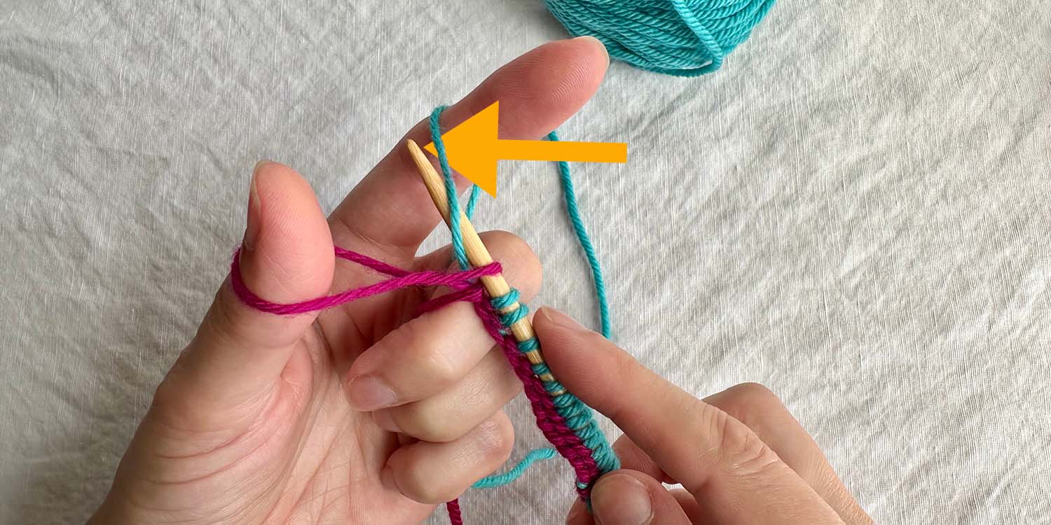 Needle inserted into finger loop from right to left with directional arrow.