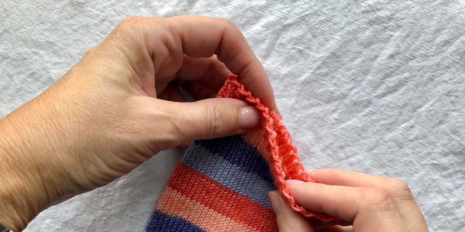 Top edge of sock cuff showing zig zag twisted bind off.